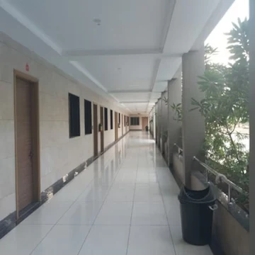 Bright tiled corridor with wooden room doors